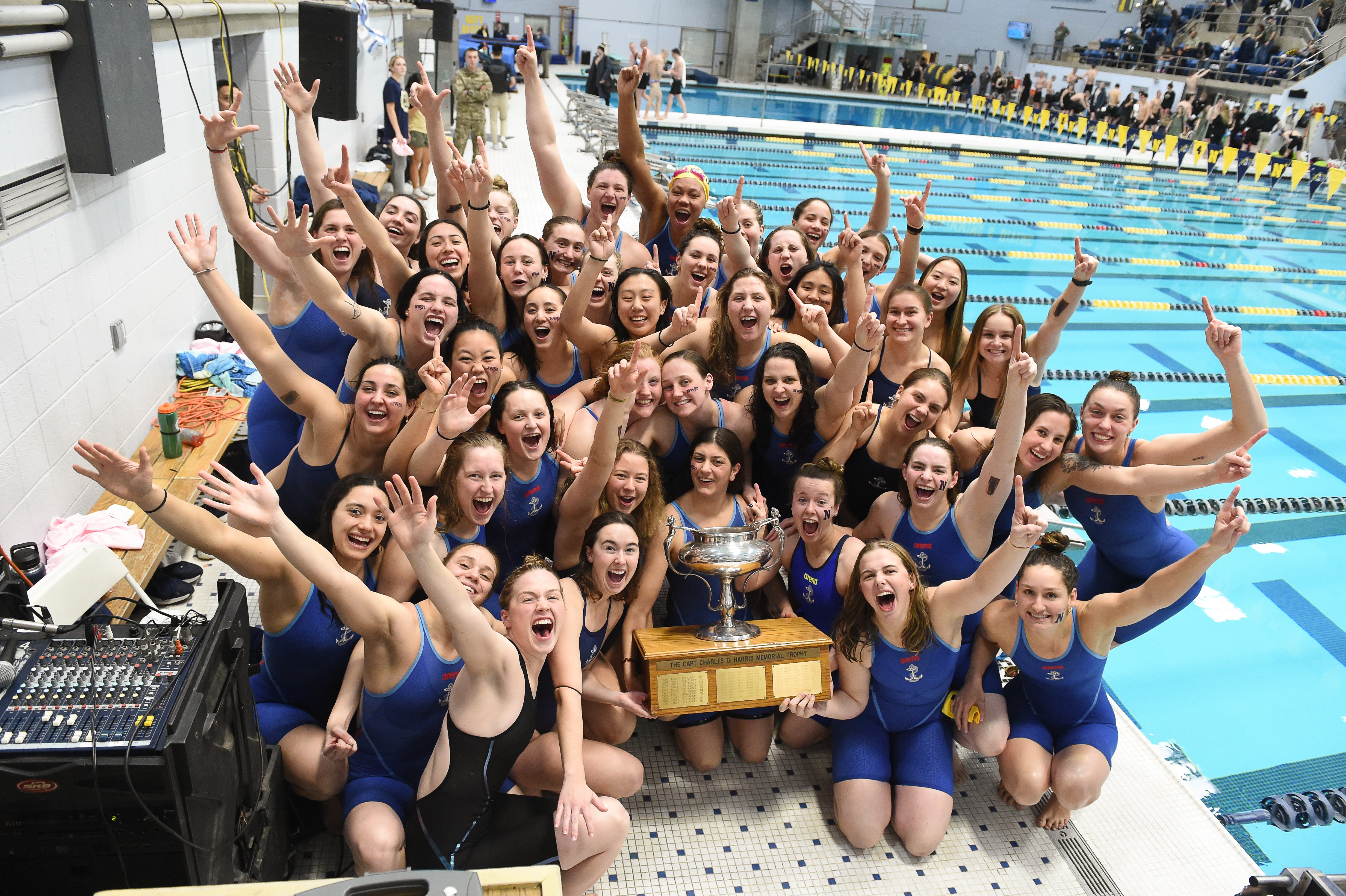Women's Swimming Team Proudly Poses With Trophy
